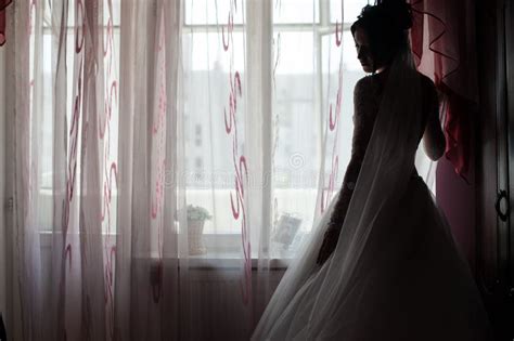 Elegant Brunette Caucasian Bride Posing Near Window Before The W Stock
