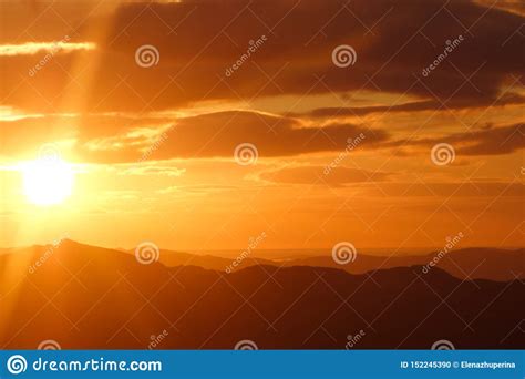 Bright Orange Sunset Over The Mountains In Montenegro Stock Photo