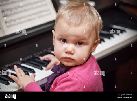 Little Baby Girl Playing Music On Classical Piano Stock Photo Alamy