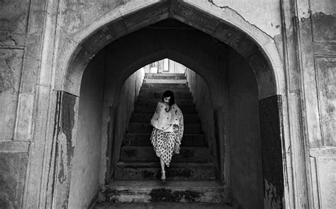 Monochrome Photo Of Woman Walking Down Stairs · Free Stock
