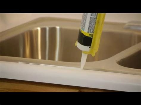 Measure and mark the kitchen sink's layout. How to Caulk & Seal a Kitchen Sink on a Laminate ...