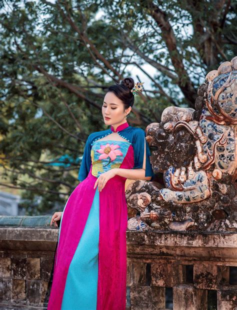 Elegant Exquisite Ao Dai With Lotus Pattern By The Side Of Hue
