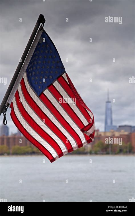 American Flag With New York City Skyline And East River In The