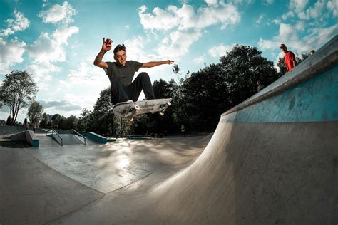 Man Wearing Grey Shirt Riding Skateboard · Free Stock Photo