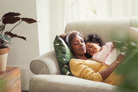 Serene Mother And Daughter Cuddling On Sofa Stock Image F0186460 Science Photo Library