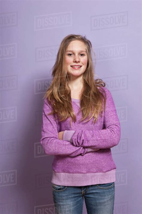 A Smiling Teenage Girl With Arms Crossed Portrait Studio Shot Stock