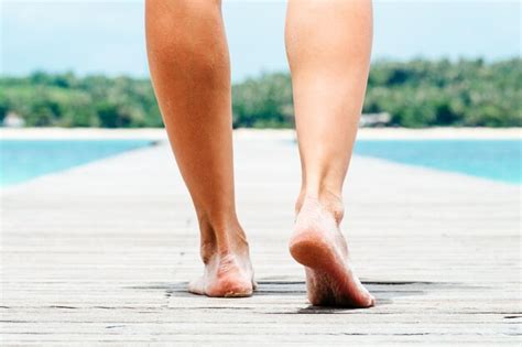 Premium Photo Low Angle Woman Walking Barefoot