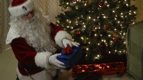 Santa Claus Putting Presents Under Christmas Tree Stock Footage Video