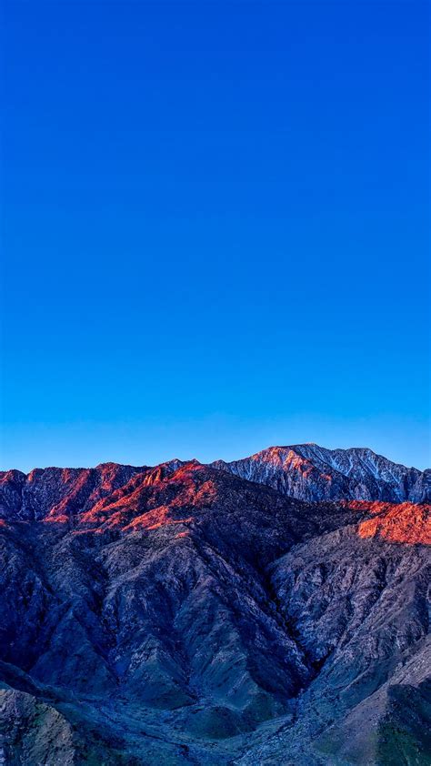 1080x1920 Blue Sky Mountains Glow Peaks Sunset Wallpaper Blue Sky