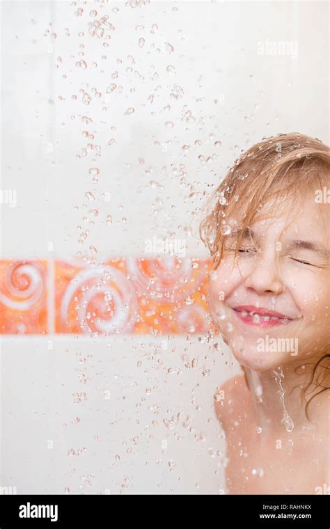 Blonde Child In The Bathroom Under The Shower Fun And Splashes Stock