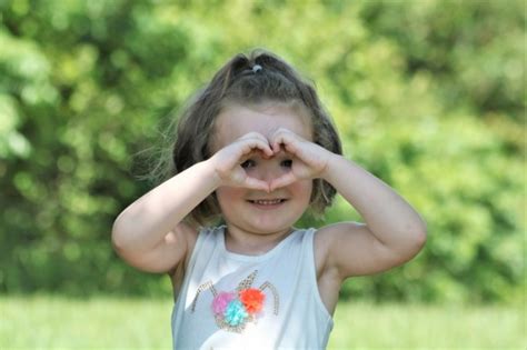 Little Girl Making Heart With Hands Free Stock Photo