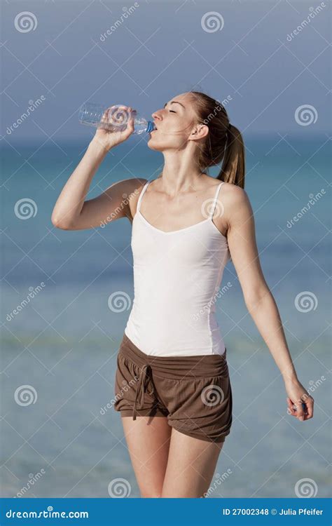 Woman Drinking Water From A Bottle On The Beach Portrait Stock Photo Image Of Drink Calcium