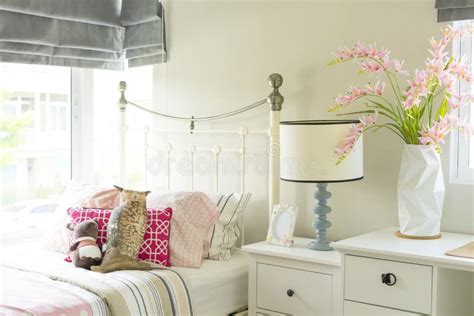 A Beautiful Bedroom In Pastel Pink Blue With A Bedside Table With A