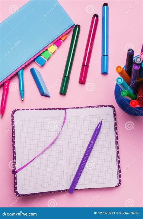 Next To The Notebook Is A Glass Of Bright Markers Stock Image Image