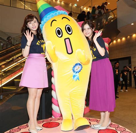 Two Women Standing Next To A Large Inflatable Toy