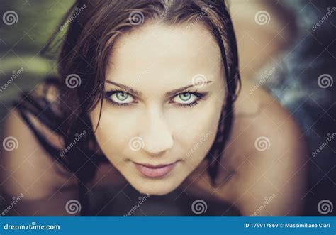 Portrait Of Young Beautiful Woman With Blue Eyes Lying In The Clear