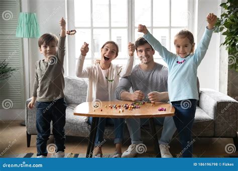 Portrait of Happy Parents Engaged in Creative Activity with Kids Stock