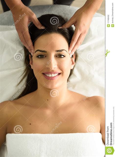 Young Smiling Woman Receiving A Head Massage In A Spa Center Stock