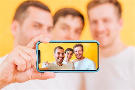Premium Photo Portrait Of Three Male Friend Taking Selfie On Smartphone