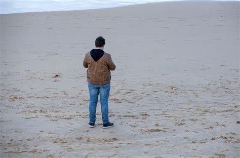 Premium Photo Man Stand On The Beach Sand