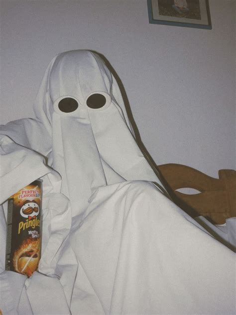 A Person In A Ghost Costume Is Holding A Cereal Box And Looking At The