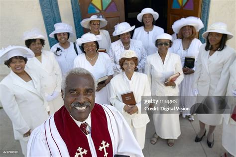 Elevated View Of Smiling Priest Standing In Front Of A Congregation