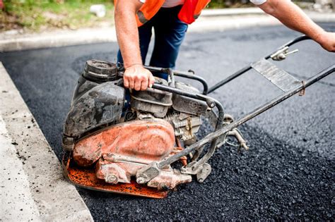 Asphalt Worker At Road Construction Site With Comp Stock ...