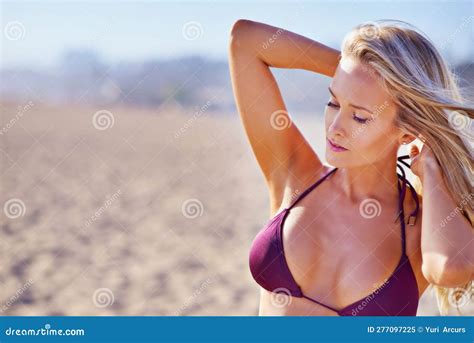 Relishing The Summer Rays A Sun Kissed Woman Relaxing On The Beach In