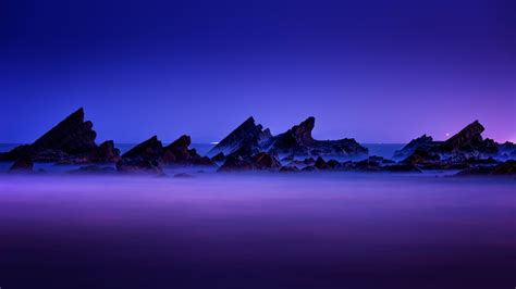 Download Wallpaper 1366x768 Purple Sky Sunset Rocks Coast Beach