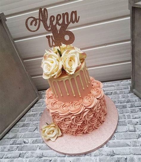 A Pink And Gold Cake Sitting On Top Of A Table