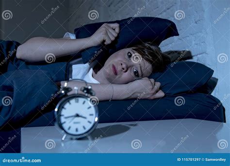 Young Beautiful Woman Lying In Bed Late At Night Suffering From