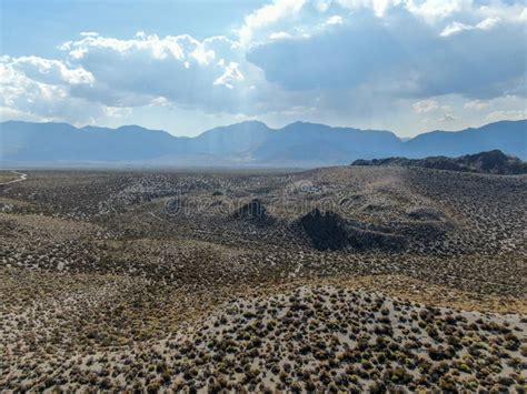 Aerial View Of Dusty Dry Desert Land And Mountain On The Background In