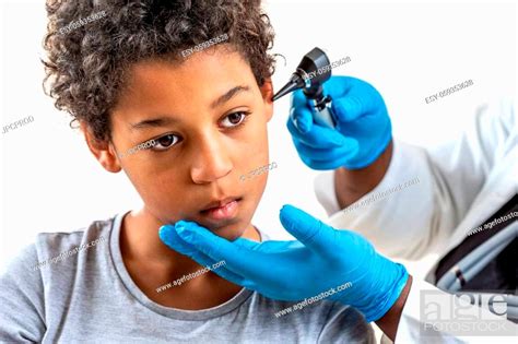 Ent Physician Looking Into Patients Ear With An Instrument Child