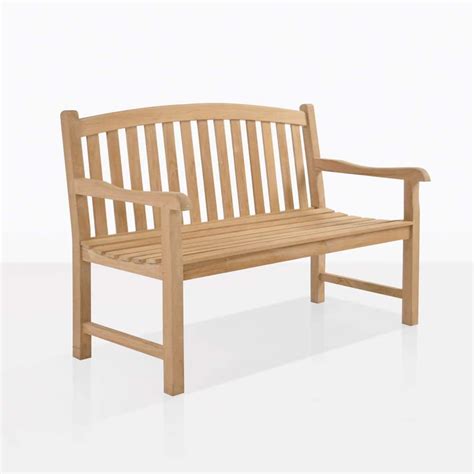 A Teak Bench With A Classic Design That Features A Graceful Arc Along The Top Of The Bench Seat