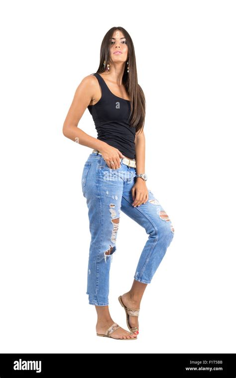 Young Casual Woman In Torn Jeans Posing At Camera Full Body Length Portrait Isolated Over White