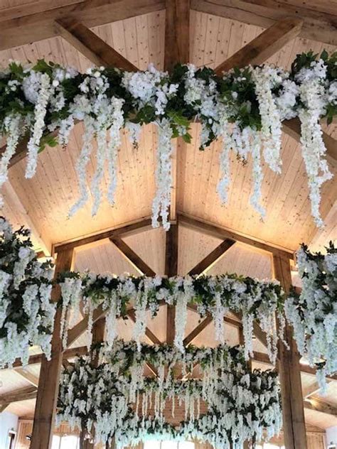 Simply tuck in some real greenery and adorn with some plastic bulbs or pine cones. Hanging Garlands for Wedding Hire - Uplit Event Hire