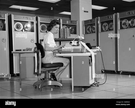 1960s Woman In Mainframe Computer Room Surrounded By Many Data Tape