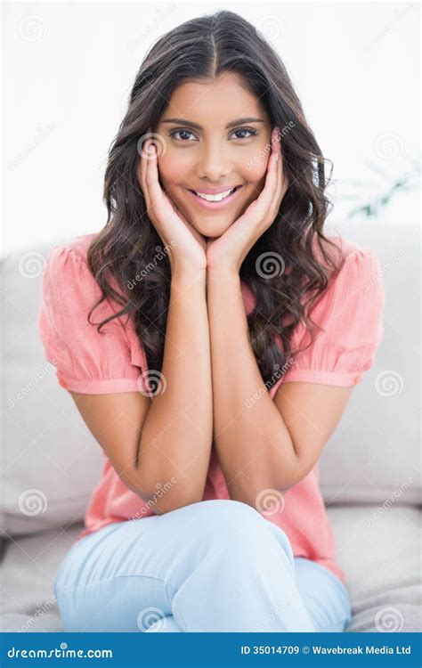 Happy Cute Brunette Sitting On Couch Touching Her Cheeks Stock Image Image Of Mixedrace