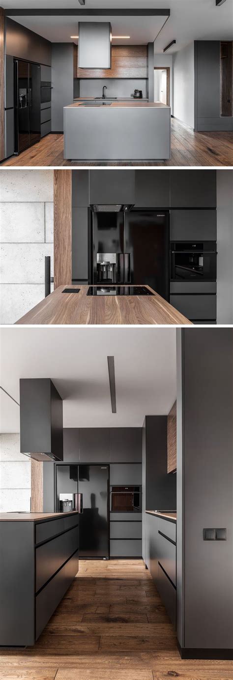 Kitchen decor with grey walls. In this modern kitchen, dark grey walls and cabinets have been paired with glossy black ...