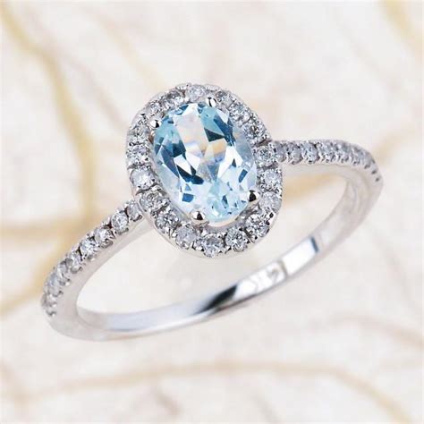 A beautiful aquamarine and diamond engagement ring, adorned with approximately 1 carat of diamonds. Aquamarine Engagement Ring - 7x5mm Oval Aquamarine Wedding ...