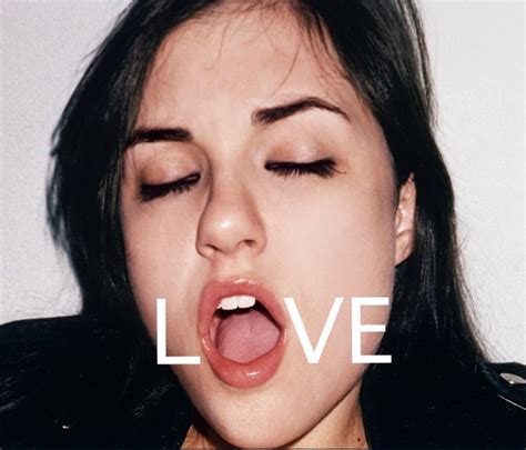 A Woman Sticking Her Tongue Out With The Word Love Above Her Mouth And