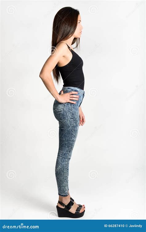 Young Woman Wearing Black Tank Top And Blue Jeans Stock Photo Image