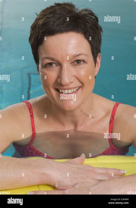 Germany Nuremberg Mature Woman In Swimming Pool Portrait Smiling