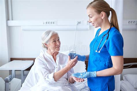 Nurse Giving Medicine To Senior Woman At Hospital Stock Image Image