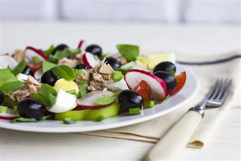 Nicoise Salad With Tuna Egg Cherry Tomatoes And Black Olives Stock