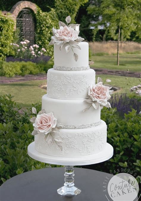 three tiered wedding cake with pink flowers on top