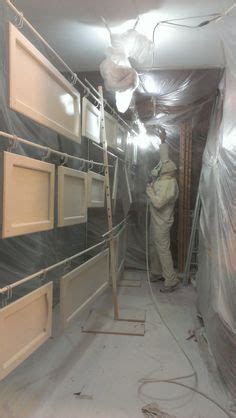 Hanging wreaths on my cabinets. My husband spray-painted our cabinet doors while they were ...