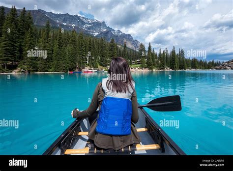 Tourist Canoeing On Moraine Lake During Summer In Banff National Park