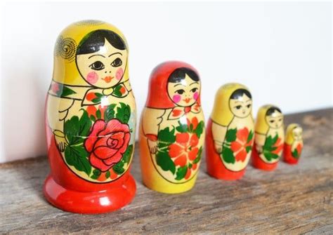 The Matry Dolls Are Lined Up Next To Each Other On A Wooden Table With