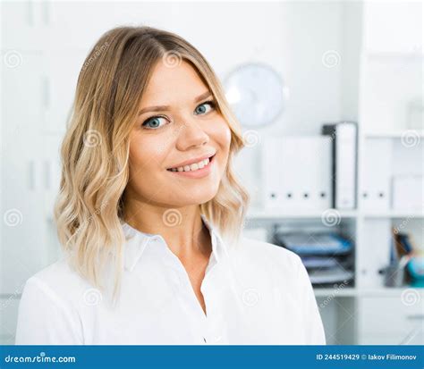 blonde woman in corporate type clothes in well lit office close up stock image image of smile